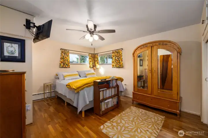 Primary bedroom w/two windows.