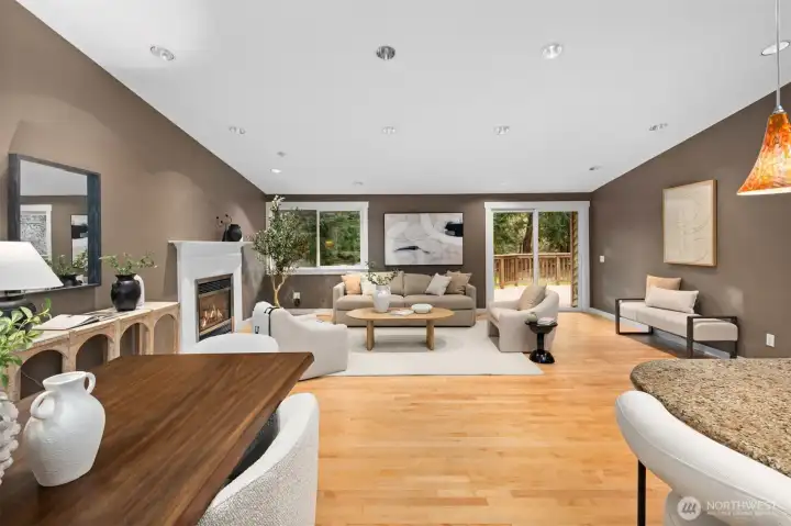 High vaulted ceilings and expansive skylights flood the main floor with beautiful natural light, creating an airy, uplifting atmosphere from the moment you step inside. Gorgeous hardwood floors add warmth and timeless elegance, perfectly complemented by tasteful designer paint that brings a fresh, modern feel to every space. At the heart of it all, a cozy fireplace invites you to gather, unwind, and enjoy quiet evenings in comfort and style.