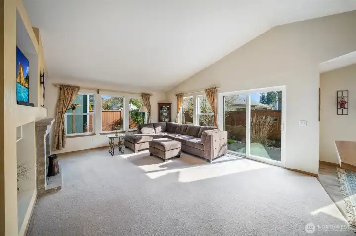 Vaulted ceilings and large banks of windows in the living room make the space feel bright and airy