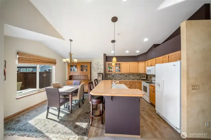 Spacious kitchen with breakfast bar is open to dining and living areas