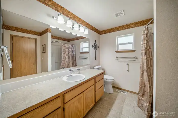 Primary ensuite bath with plenty of counter and cabinet space. New comfort height toilet