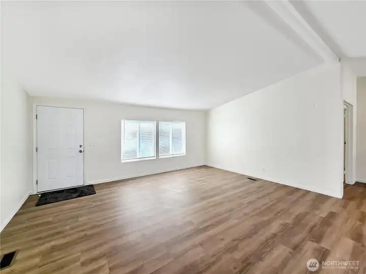 Spacious living room with a versatile layout that easily accommodates your furnishings. Fresh paint and new flooring and blinds installed.