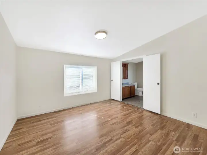 Spacious primary bedroom featuring double-door entry into the primary bath  that adds a sense of luxury and provides easy access.