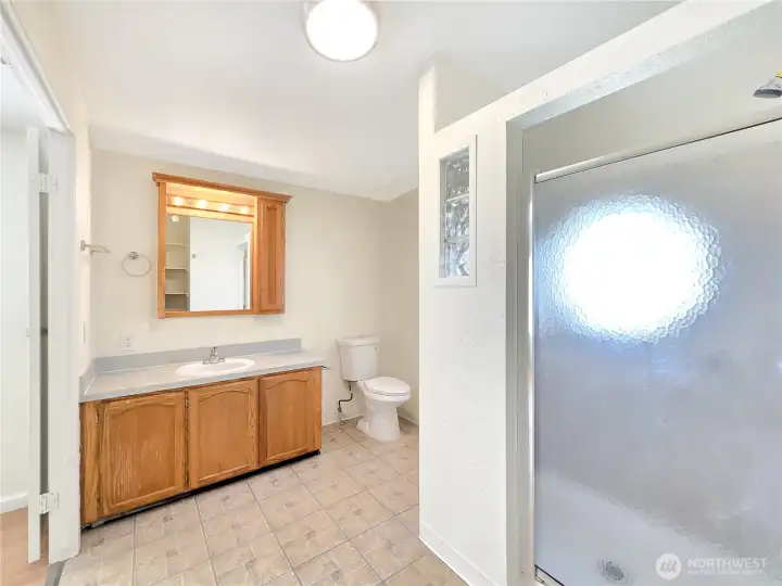 Primary bath with a large single-sink vanity and open floor space that creates a comfortable, easy-to-use layout.