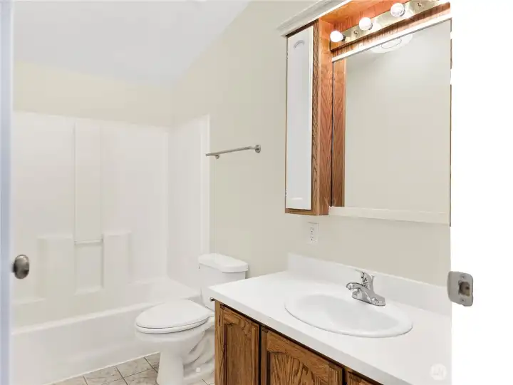 Bright hall bath with great lighting and a clean, functional layout.