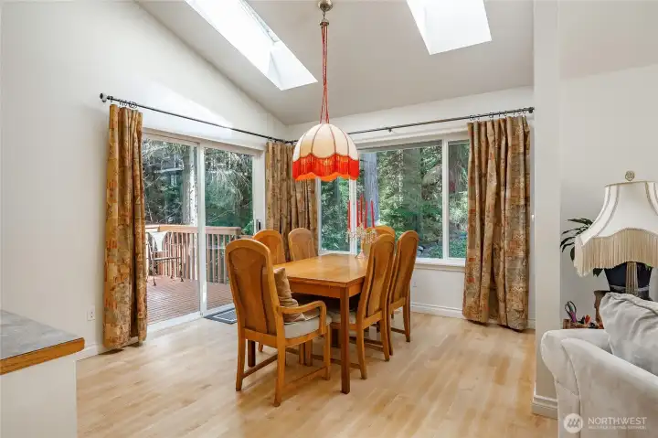 The vaulted ceilings with skylights shown here really amplify how bright this home is. The dining area flows seamlessly from this space, making it well-suited for both larger gatherings and casual everyday use.