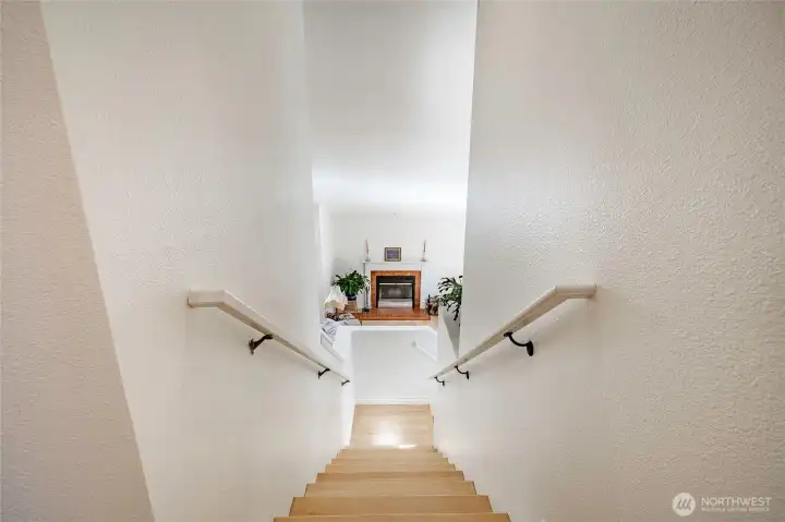 The living room fireplace serves as a striking focal point, beautifully visible from the upstairs.