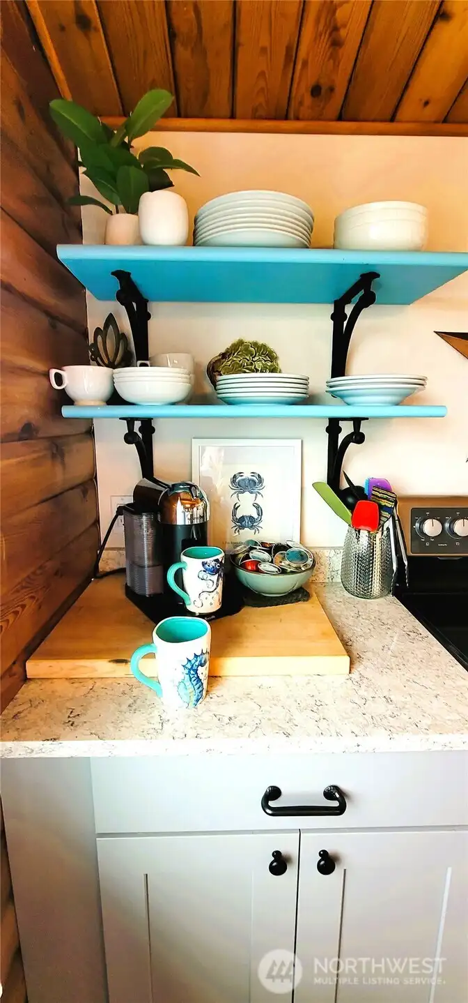 A charming coffee bar nestled in the kitchen, where warm wood tones and thoughtful design create the perfect space for brewing your morning favorite while enjoying ocean views.