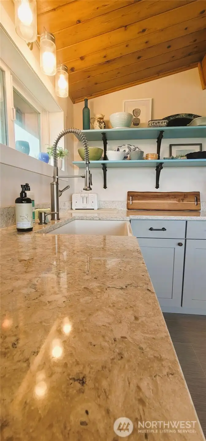 Timeless charm meets modern elegance with stunning quartz countertops, offering durability and style in this inviting kitchen designed for gatherings and gourmet creations.