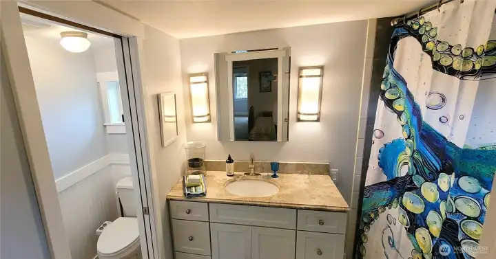 A serene spa-like bathroom featuring elegant stone countertops and a luxurious jetted soaking tub. Thoughtfully designed for relaxation, the space ensures comfort and tranquility in this refined retreat.