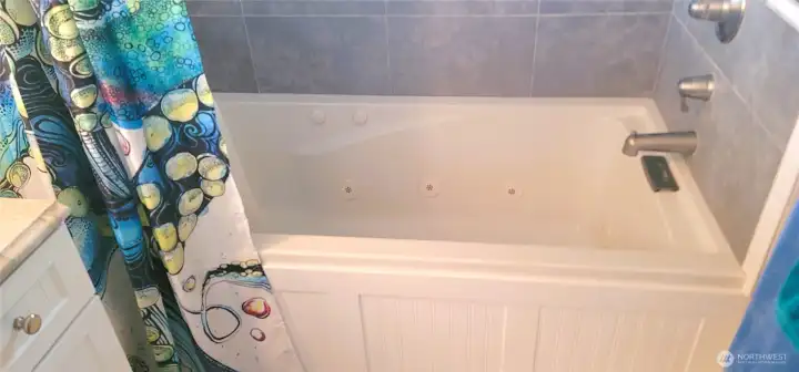 A spa-like ensuite bathroom featuring a luxurious jetted tub and elegant finishes—creating the perfect space to relax and unwind in coastal comfort.