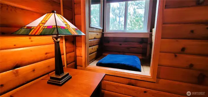 A thoughtfully designed space where the reading nook and closet seamlessly blend, creating a cozy and functional retreat.