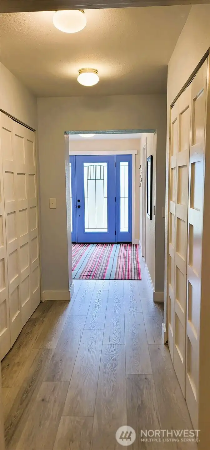 A welcoming first-floor hallway that seamlessly guides guests from the front door through the heart of the home, leading upstairs to the second level. The thoughtful architectural design creates an inviting and functional passageway, enhancing the home's flow and character.