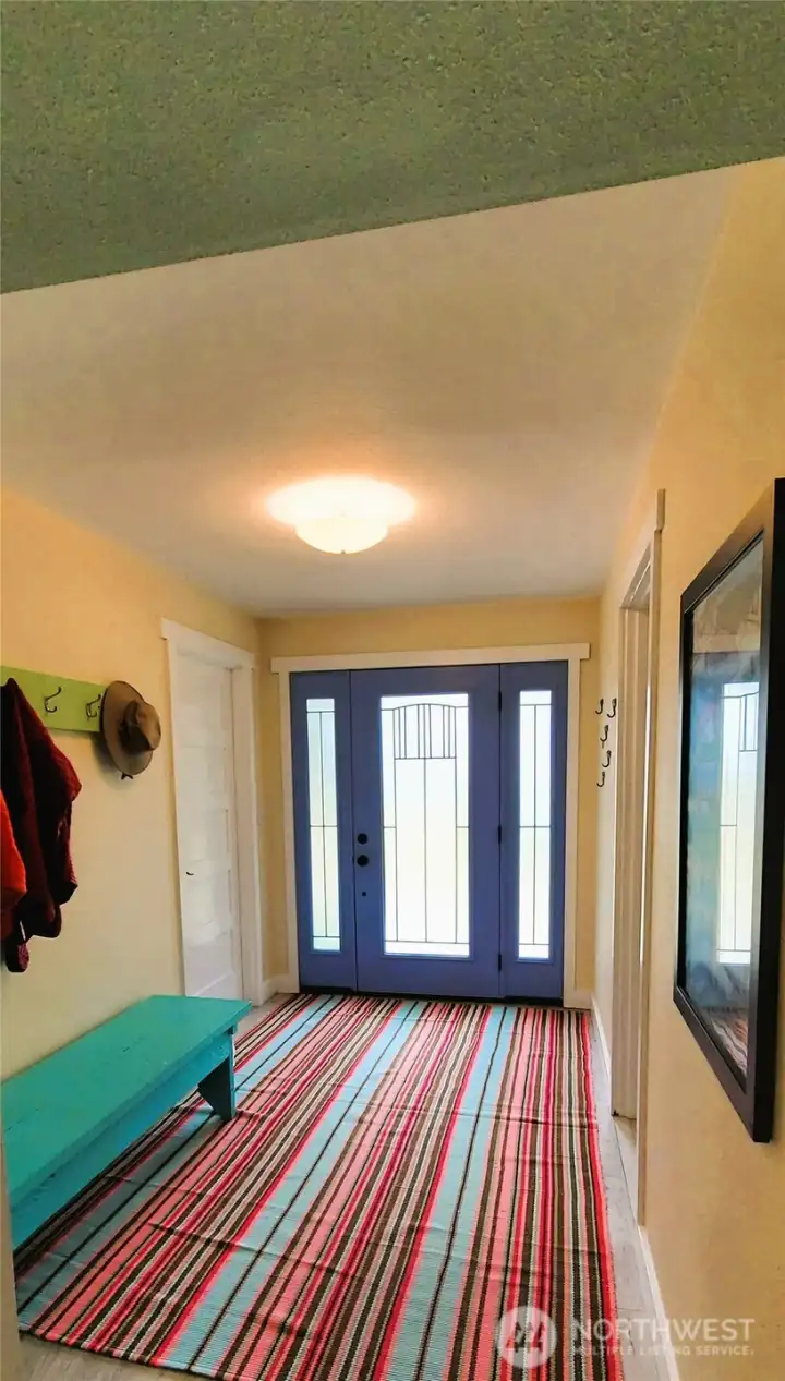 A welcoming first-floor entryway that effortlessly connects to the utility and storage room, a flexible nursery or office space, and an inviting staircase leading to breathtaking ocean views.