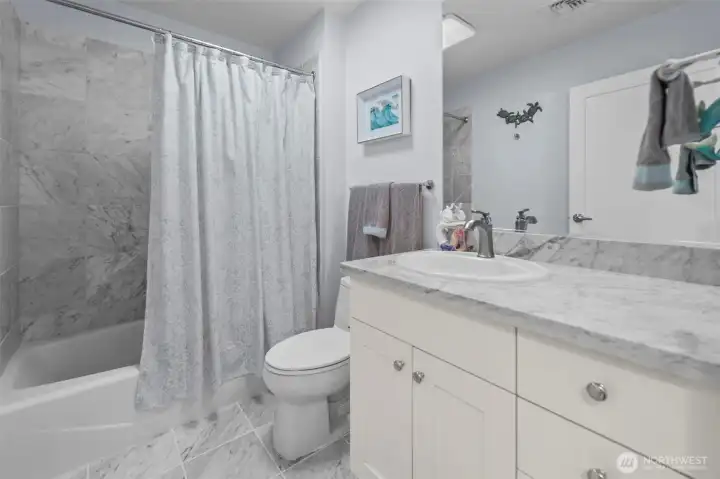 Full bathroom with marble floors and granite countertops
