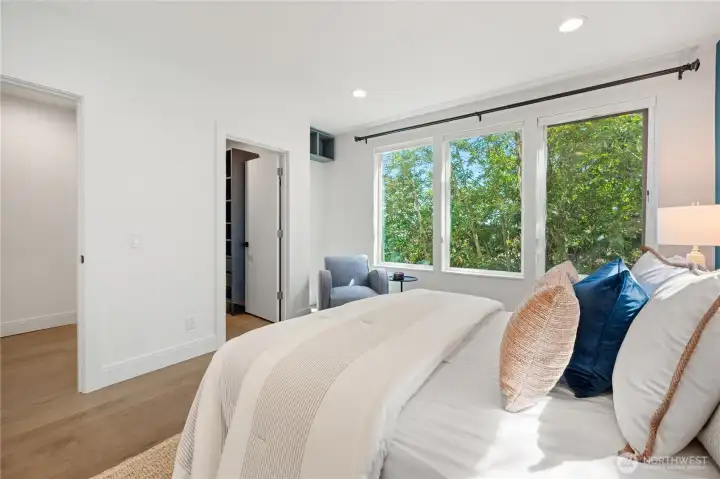 Bright primary bedroom and oversized windows Bright primary bedroom and oversized windows
