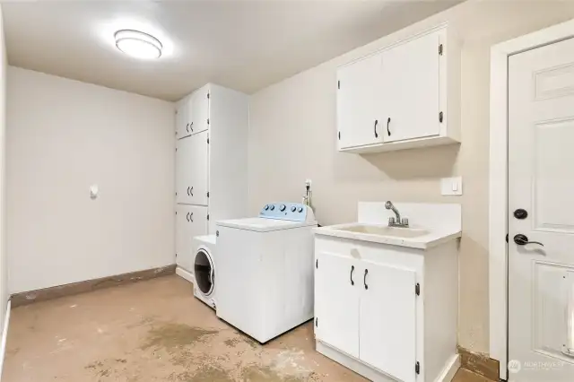 Utility/laundry room with door to back yard