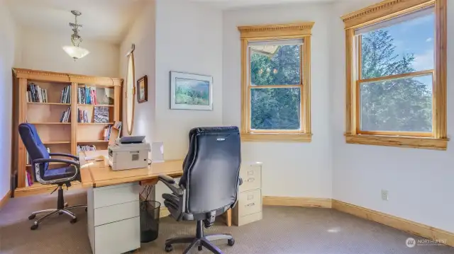 This bright and functional in-home office provides an ideal space. Custom built-in shelving offers ample storage for books and supplies, while the open layout allows for a variety of desk configurations. Conveniently located on the upper level with access to the laundry area.