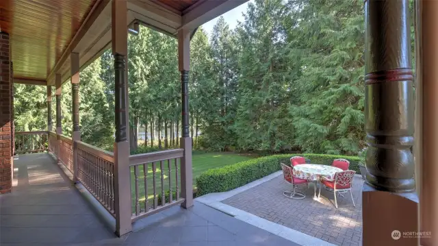 Step outside to an expansive deck and patio area that seamlessly blends with the surrounding natural beauty. Perfect for outdoor dining and entertaining, this spacious setting is framed by lush greenery and offers tranquil views of the towering trees and nearby lake.