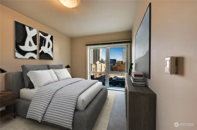 Spacious guest bedroom with floor to ceiling window & city views to enjoy.