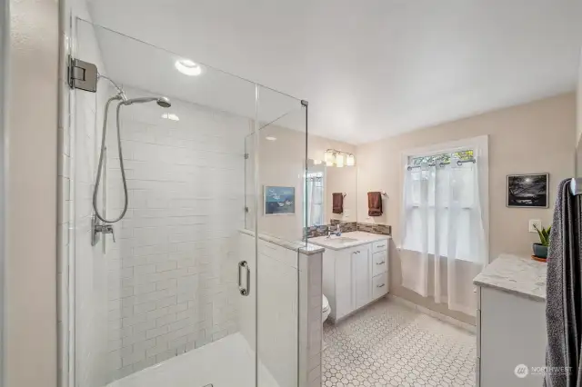 Updated 3/4 bathroom upstairs with full subway tile surround shower, tile floors, undermount sink + additional vanity area for storage.