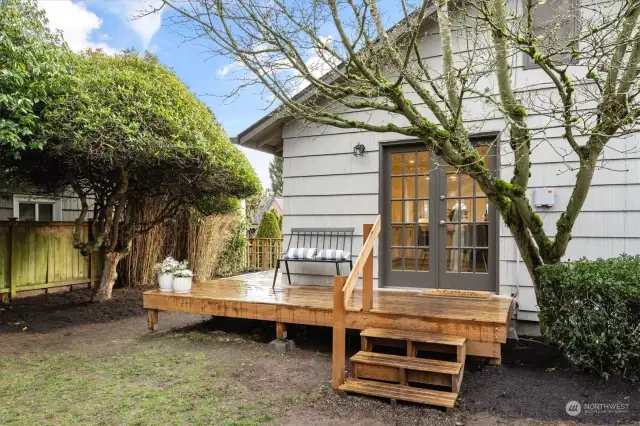 Large, fully fenced, backyard with deck