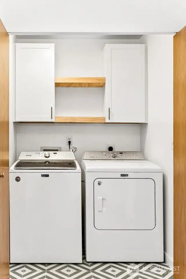 Upstairs laundry with new flooring and extra cabinets.