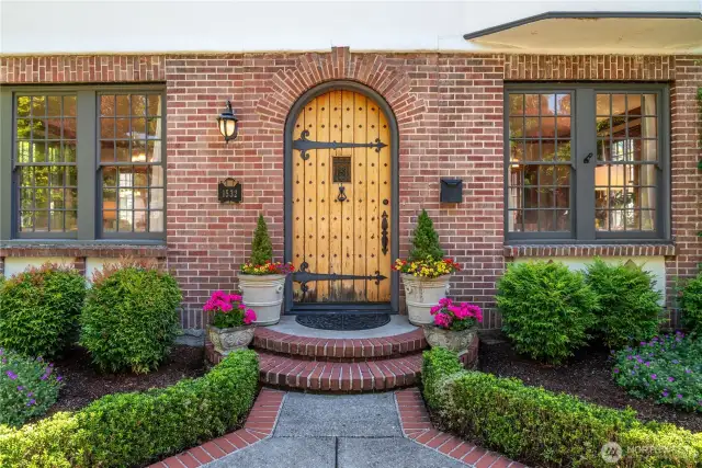 Beautiful landscaping, original front door and windows greet you when approaching.