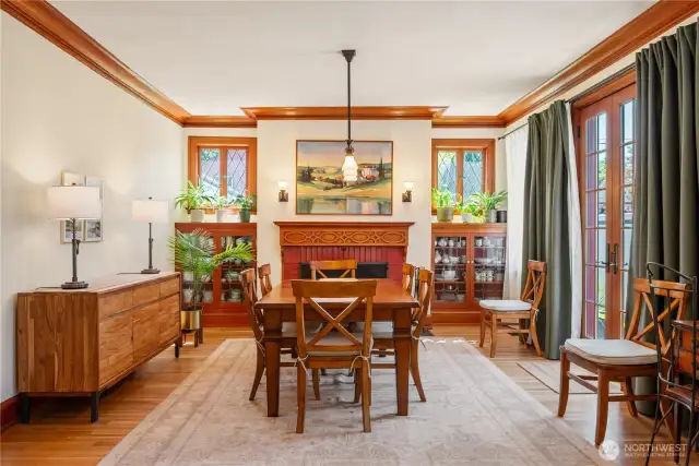 Room for many in the dining room with inviting fireplace and built-in cabinetry.
