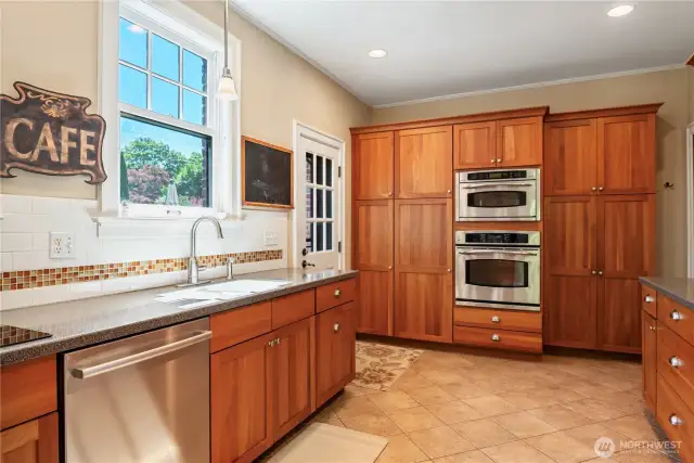 The timeless, updated kitchen has easy access to the backyard.