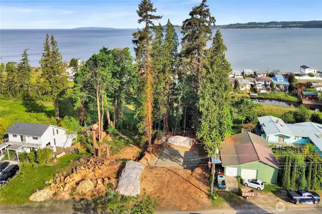 Nice overview of lot seen with homesite cleared and ready to go.  Sellers rent the neighbors green shop to the right for $750/mo