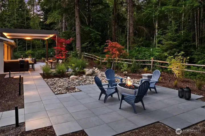 The landscape, green space, and walkways are beautifully illuminated with Lumiere outdoor lighting, offering timer functions and full color control for effortless ambiance