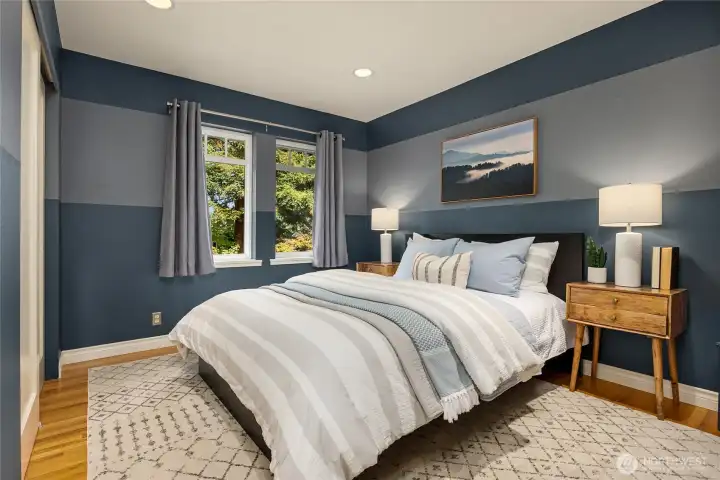 The second bedroom on the upper level with designer paint overlooks the back yard.