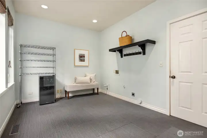 The mudroom off the kitchen has plenty of room and another washer/dryer hook up!