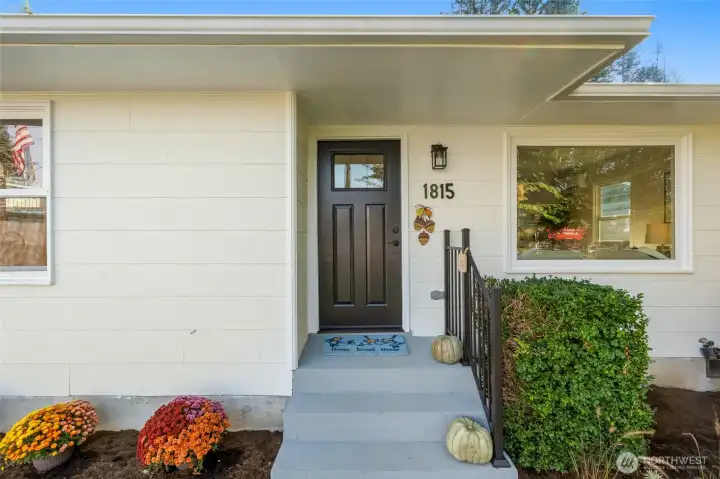 New railing and front door and colorful chrysanthemums welcome you to come on in!