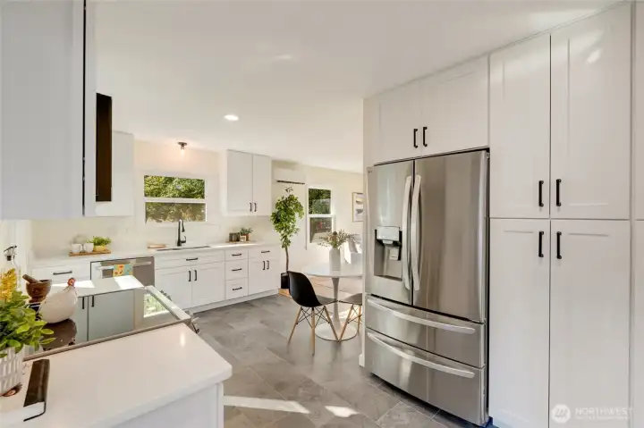 The pantry cabinets to the right of the refrigerator are deep with pull out drawers offering a place for everything.