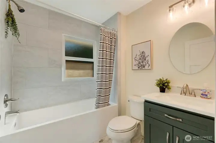 Deep soaking bathtub/shower, ceiling height tile, full storage cabinetry.