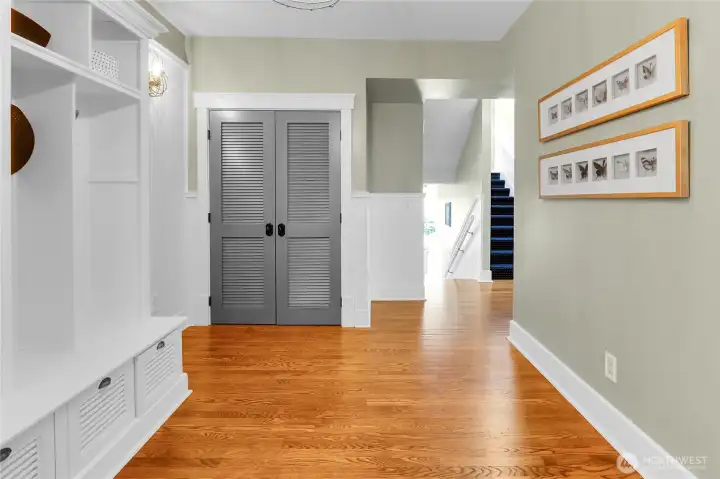 Spacious front entry featuring a built-in coat rack and integrated storage, plus coat closet offers a functional and welcoming arrival with plenty of space to stay organized