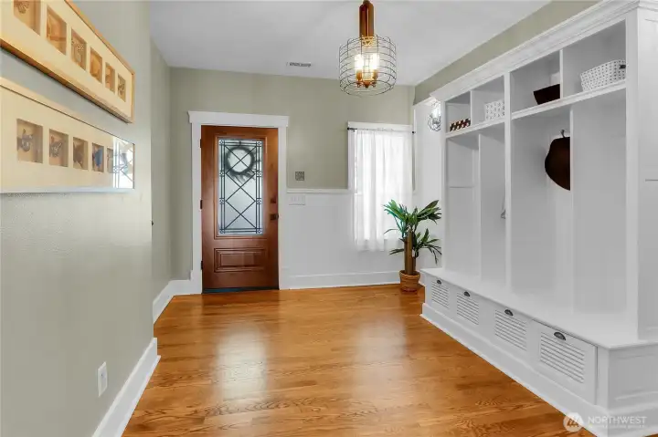 Spacious front entry featuring a built-in coat rack and integrated storage, plus coat closet offers a functional and welcoming arrival with plenty of space to stay organized