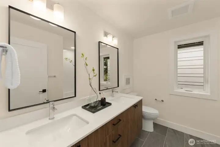 Upper full bath with dual sinks.