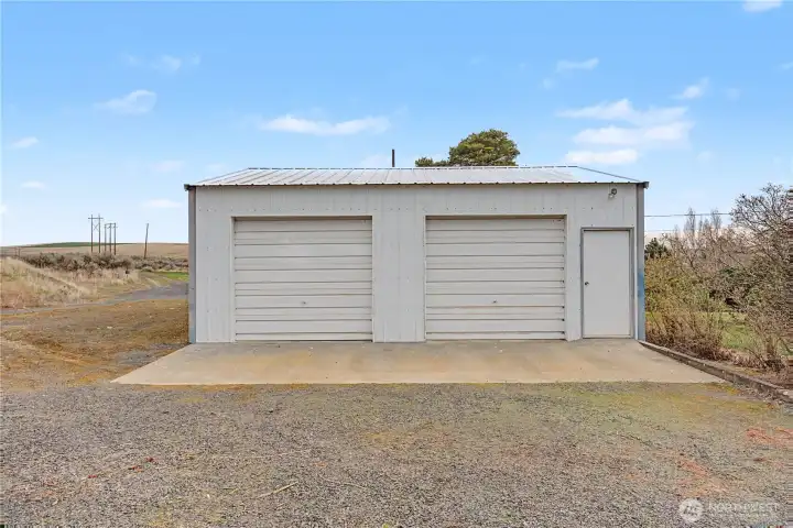 Detached 2 car shop and there's a 2 car overside carport behind