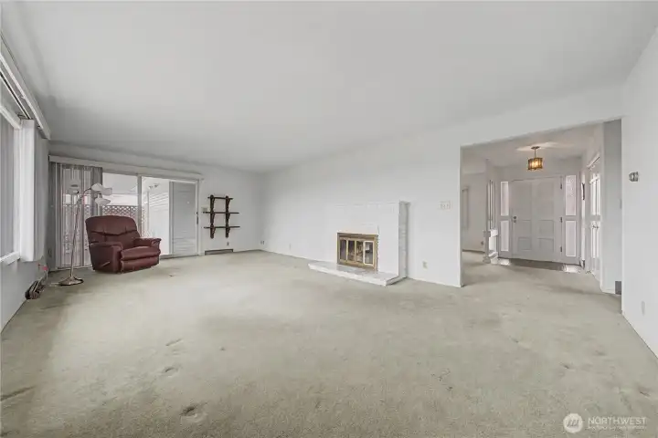 Living room with gas fireplace and walk out to the backyard patio and deck.