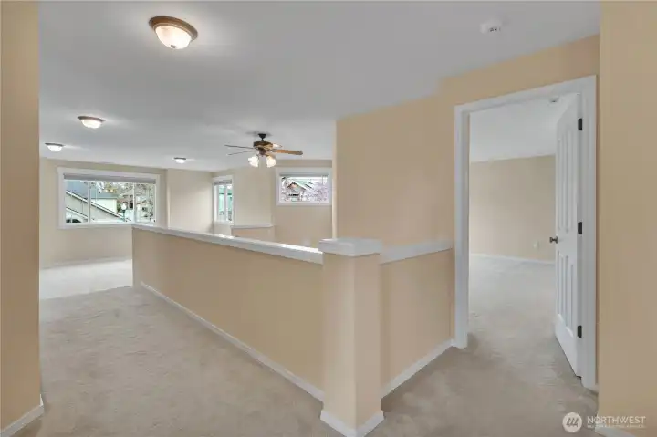 Upper Hallway with access to the Bonus Room, Laundry Room, 3 Guest Beds, Full Guest Bath, and Primary Suite (to the right).