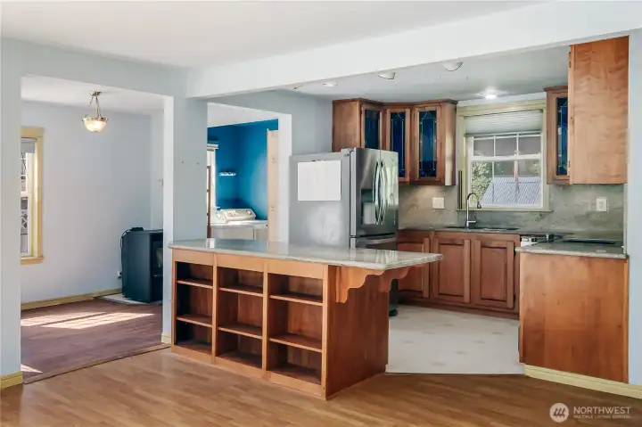 Extra-large eating bar with slab granite provides room on each side for extra guests along with storage on both sides