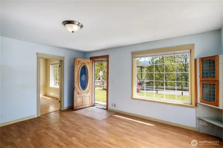 Large great room with laminate flooring & lots of natural light.