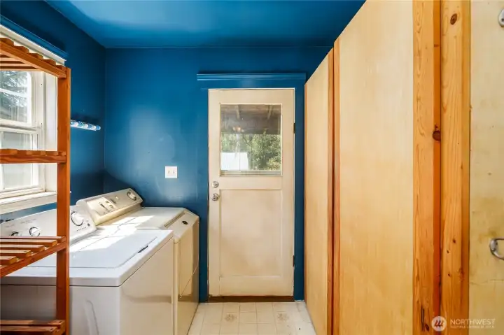 Laundry area with built in pantry & storage to the right.