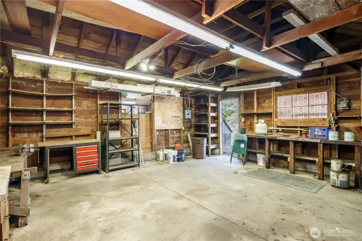 Oversized garage with built in work benches.