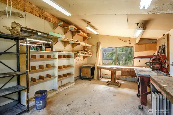 Wood working shop with lots of shelving & storage for projects. The wood lathe even stays.