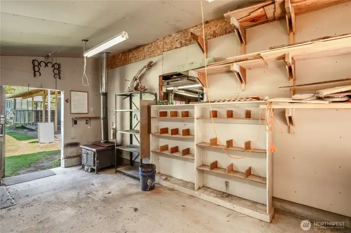There is a wood stove in the wood shop for working on projects in the winter.