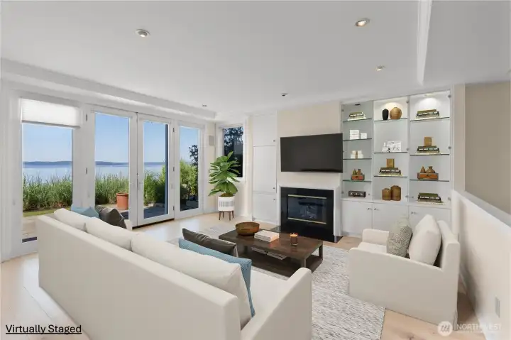 This end-unit home with waterfront access features durable flooring throughout the main level, illuminated built-ins, and elegant French doors that open to a private patio—an ideal space for relaxing, entertaining, or curling up with a good book. This end-unit home with waterfront access features durable flooring throughout the main level, illuminated built-ins, and elegant French doors that open to a private patio—an ideal space for relaxing, entertaining, or curling up with a good book.